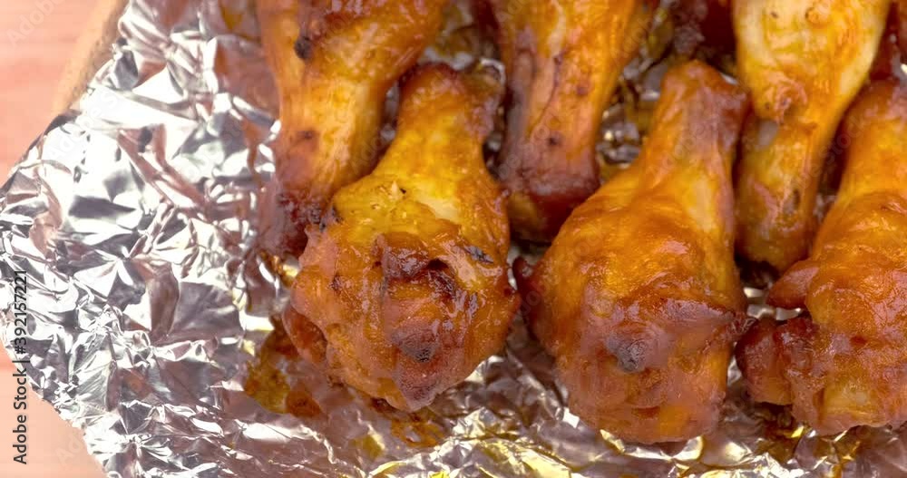 Truck shot of drumette chicken wing stick grilled on aluminium foil Truck shot of drumette chicken wing stick grilled on aluminium foil