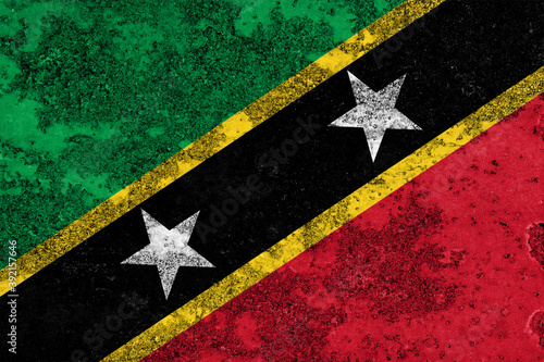 Flag of Saint Kitts and Nevis painted on the old grunge rustic iron surface. Abstract paint of Saint Kitts and Nevis national flag on the iron surface