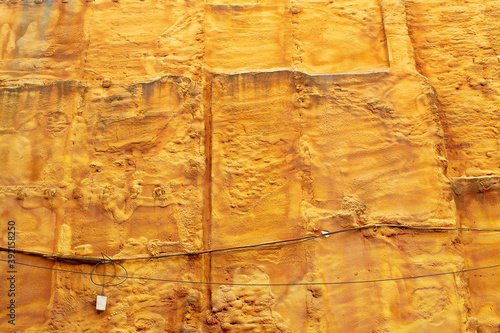 View of a wall on a construction site sprayed with yellow insulation