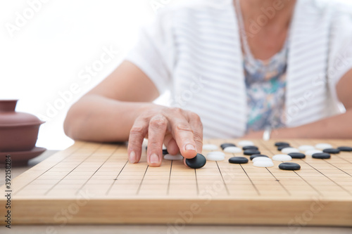 Chinese old lady is playing Chinese Go
