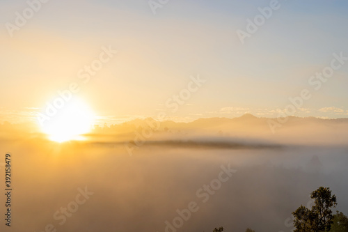 White puffy like cloud stretching to foggy horizon in the bright morning. View at sunrise with puffy foggy.