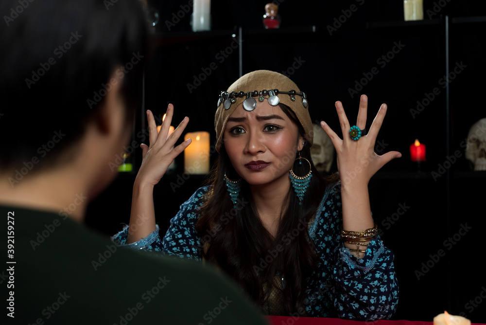 Φωτογραφία Portrait of Asian beautiful Gypsy fortune teller woman in dark room with custome