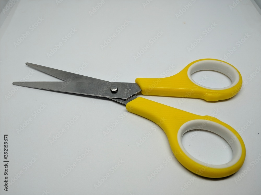 Yellow scissors for cutting isolated on white background.
Yellow scissors for cutting isolated on white background.