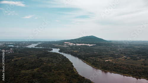 Panorama view of the meandering river and the mountain in countryside. river curve along forest.