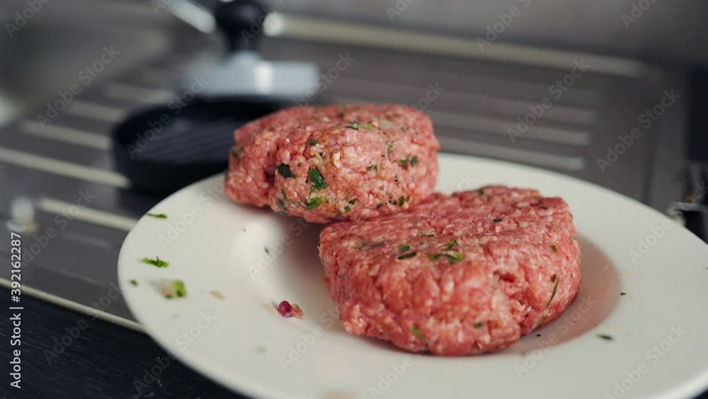 Minced beef patties formed into a burger being revealed, shot in 4k Minced beef patties formed into a burger being revealed, shot in 4k