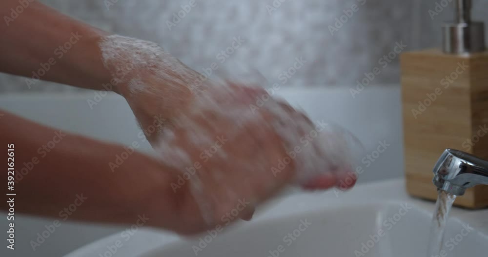 woman cleaning hands using soap to prevent virus spread woman cleaning hands using soap to prevent virus spread