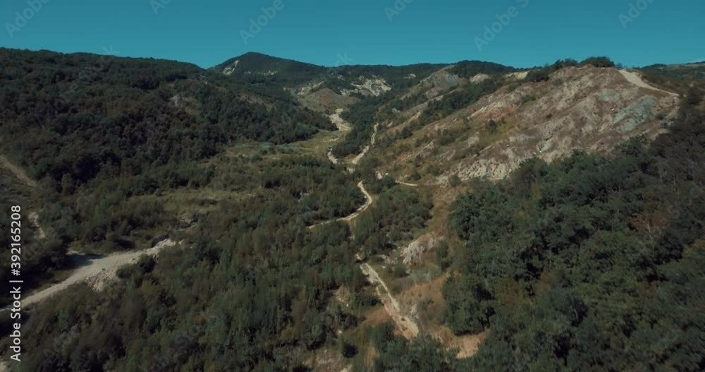 Drone aerial shot of Mountains, peaks, cliffs, rocks, ridges, landscape, green grass, blue sky, nature, uncultivated nature , roads and trees Drone aerial shot of Mountains, peaks, cliffs, rocks, ridges, landscape, green grass, blue sky, nature, uncultivated nature , roads and trees