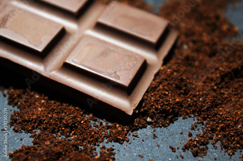 Chocolate bar close up with chocolate powder
