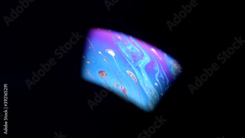 Glimpse Of Light Strikes On Abstract And Colorful Surface Of Soap Bubble Isolated In Black Background. - macro photo