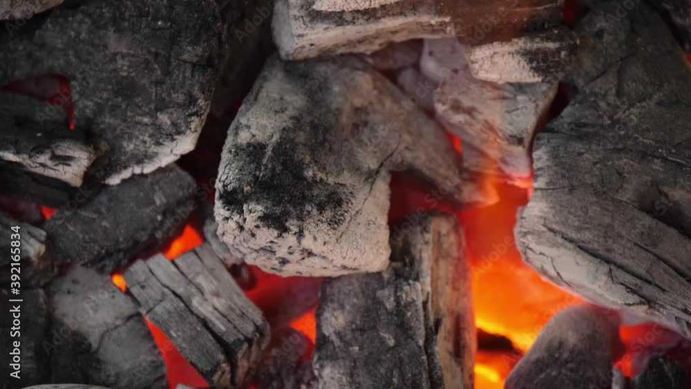 Slow motion speed close up scene of burning charcoal pile with white ash, mirage illusion movement from hot stream of air, outdoor cooking activity, crumble texture of live coal. Slow motion speed close up scene of burning charcoal pile with white ash, mirage illusion movement from hot stream of air, outdoor cooking activity, crumble texture of live coal.