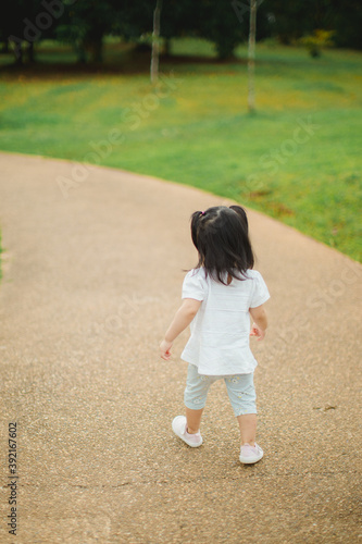 Toddler walking in the park on daylight