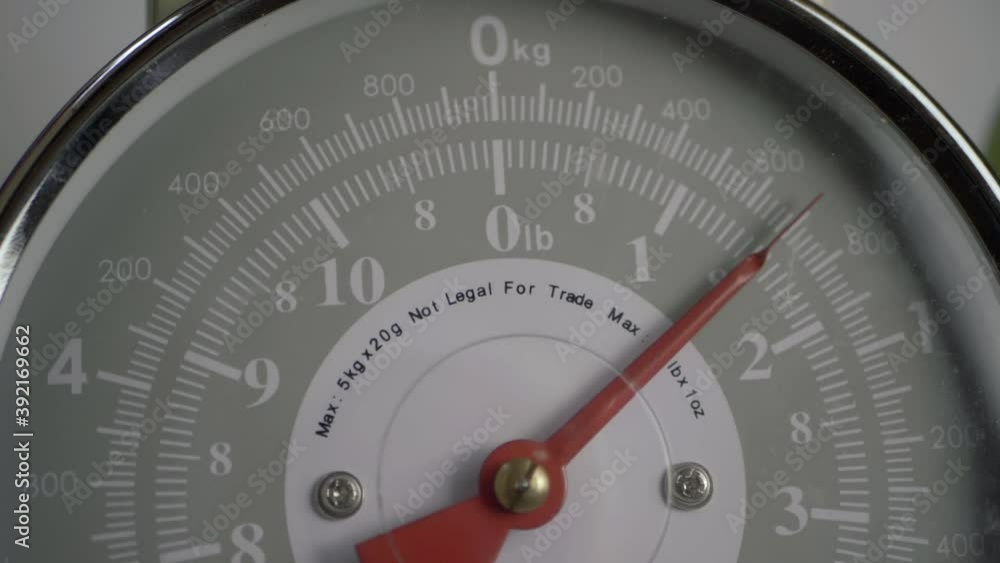 Kitchen weighing scales with moving dial close up shot Kitchen weighing scales with moving dial close up shot