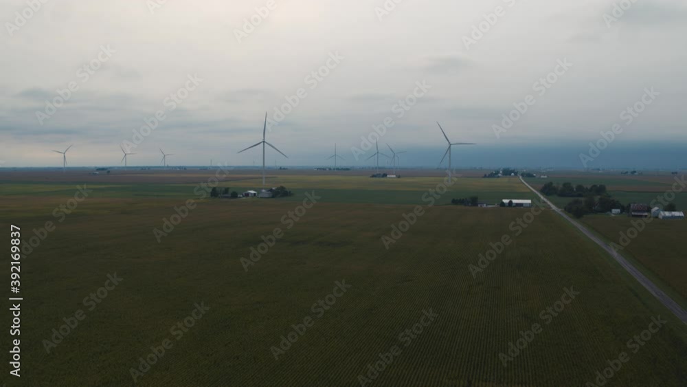 Aerial of an overcast windmill farm in a cornfield Aerial of an overcast windmill farm in a cornfield