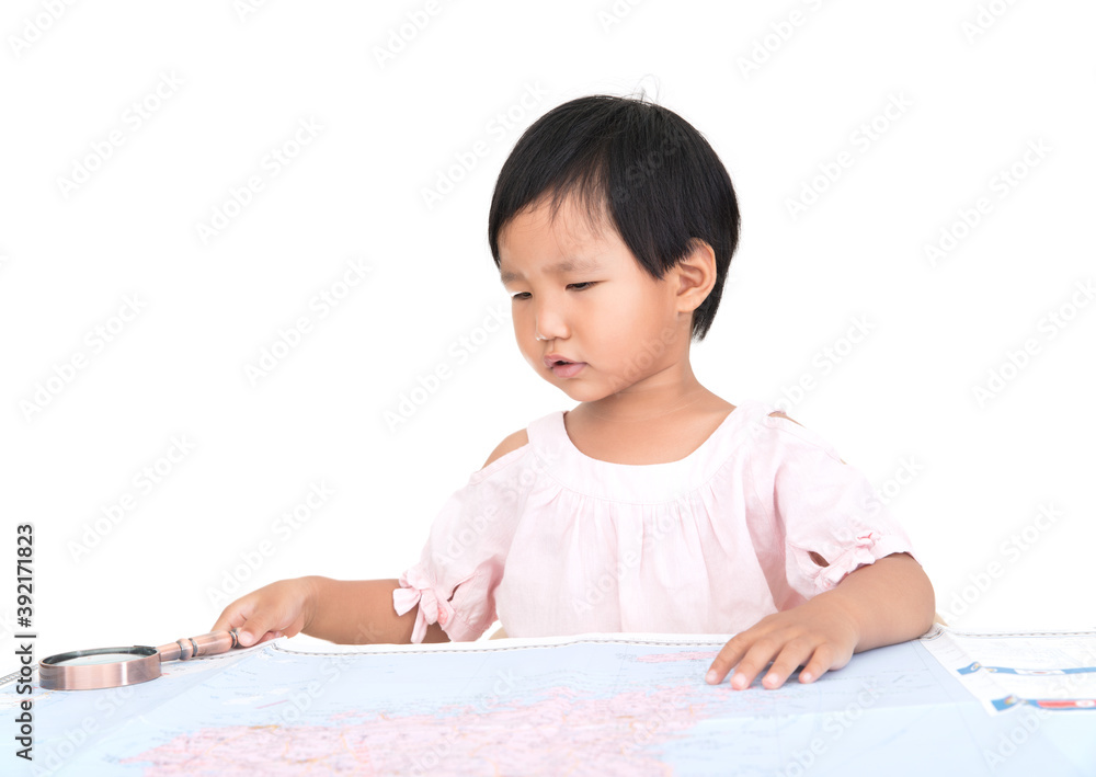 Cute Chinese little girl sitting at the table ready to view the map spread out on the table Cute Chinese little girl sitting at the table ready to view the map spread out on the table