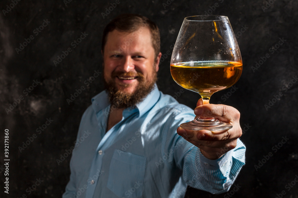 Solid bearded man in shirt with glass of whisky Solid bearded man in shirt with glass of whisky
