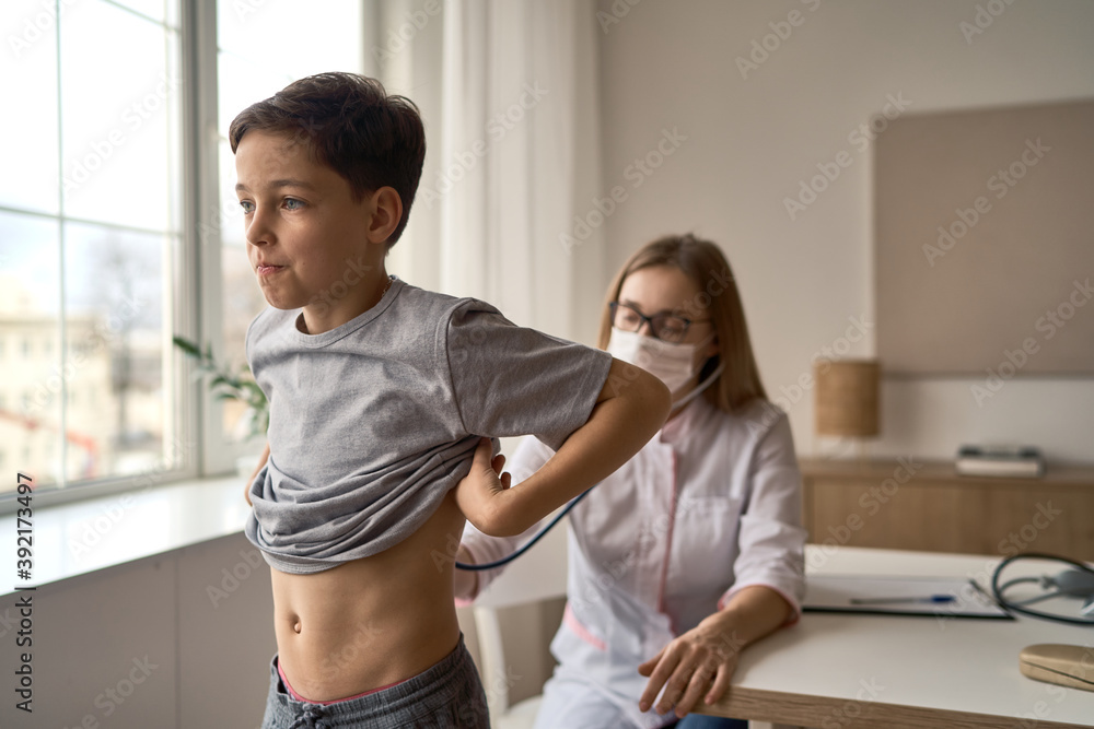 Cute boy with pleasure visiting pediatrician, scheduled check up of babys health, appointment with the family doctor, healthy lifestyle. High quality photo Cute boy with pleasure visiting pediatrician, scheduled check up of babys health, appointment with the family doctor, healthy lifestyle. High quality photo