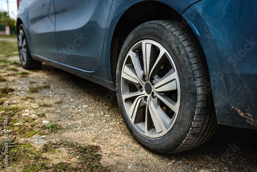 Car tire on gravel road. © Natallia
