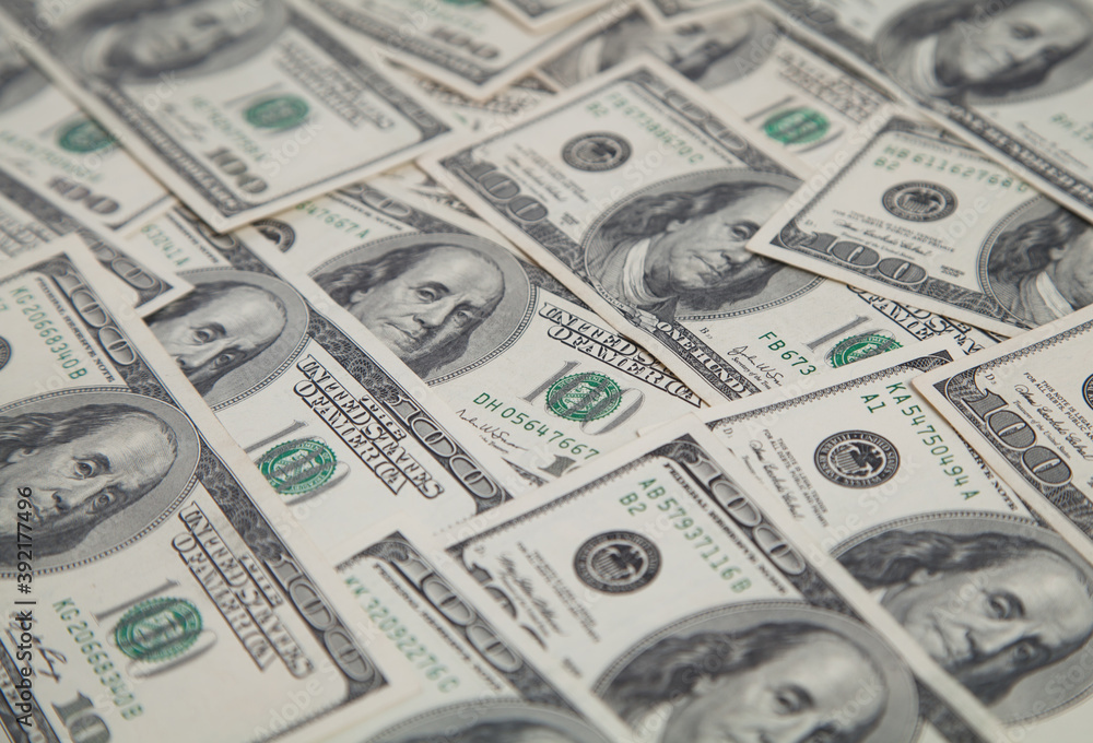 A pile of one hundred US banknotes. Dollar background image. A pile of one hundred US banknotes. Dollar background image.