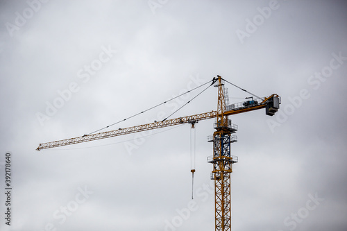 
working cranes at the construction site of high-rise buildings