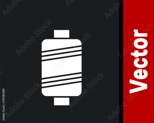 White Sewing thread on spool icon isolated on black background. Yarn spool. Thread bobbin. Vector Illustration.