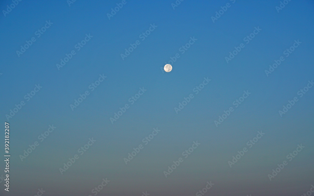 Nature scene of the moon in day time isolated with blue sky background - minimal abstract patterns          