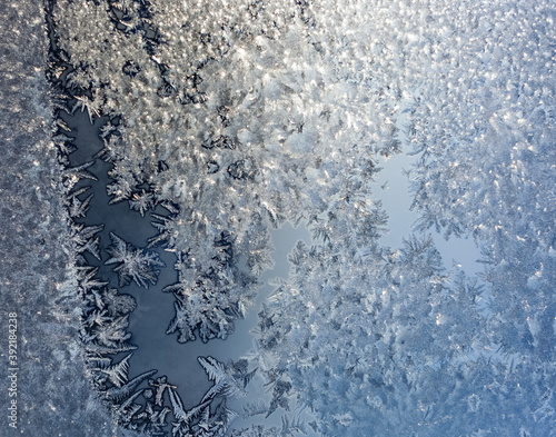 Frosty patterns on window glass in winter