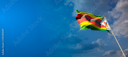 Beautiful national state flag of Zimbabwe with blank space. Zimbabwe flag on wide background with place for text 3D artwork.