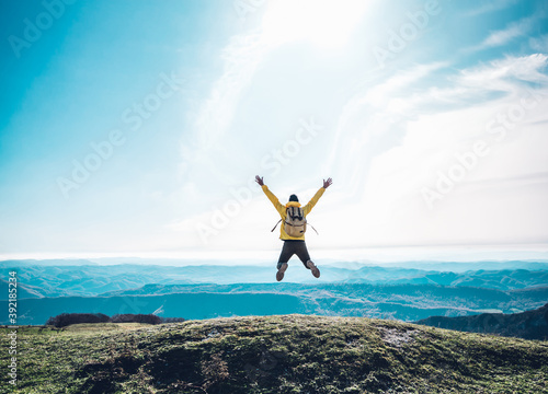 Tableau sur toile Successful man jumping on the top of the mountain - Happy hiker celebrating succ