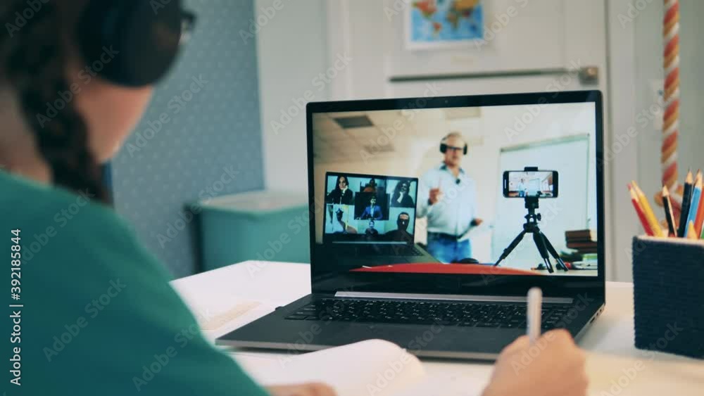 Distance education, online education, online class concept. Schoolgirl taking part in an online class remotely. Close up Distance education, online education, online class concept. Schoolgirl taking part in an online class remotely. Close up