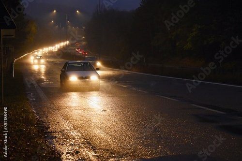 Bad weather driving - foggy hazy country road. Motorway - road traffic. Winter - autumn time.