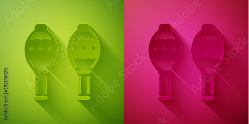 Paper cut Maracas icon isolated on green and pink background. Music maracas instrument mexico. Paper art style. Vector.