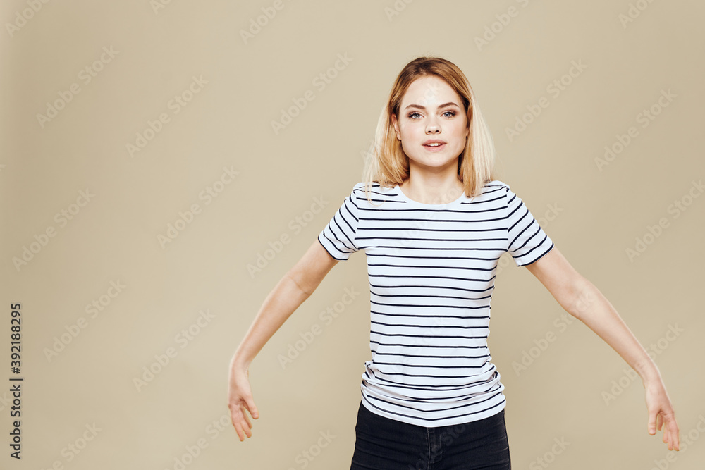 Cheerful woman striped t-shirt studio beige background lifestyle emotions