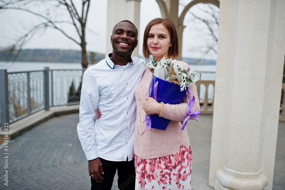 Happy multiethnic couple in love story. Relationships of african man and white european woman. Happy multiethnic couple in love story. Relationships of african man and white european woman.