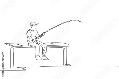 Single continuous line drawing of young happy fisher man fishing big trout fish in dock pier while sitting relax. Fishing hobby holiday concept. Trendy one line draw design vector illustration graphic