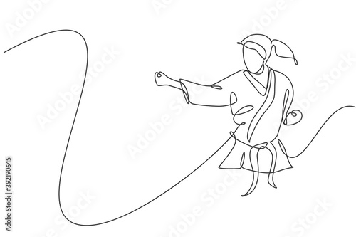 One continuous line drawing of young talented karateka girl train pose for duel fighting at dojo gym center. Mastering martial art sport concept. Dynamic single line draw design vector illustration