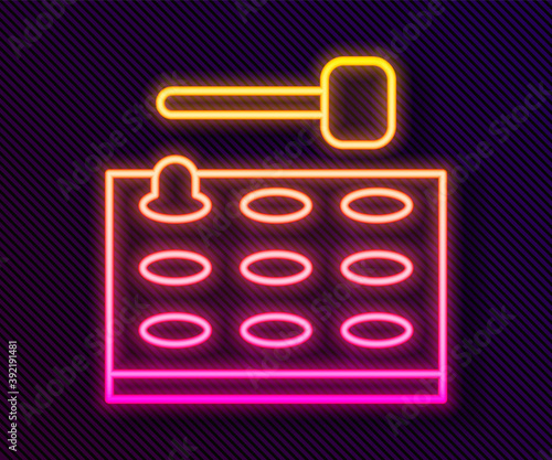 Glowing neon line Arcade game machine with hammer icon isolated on black background. Amusement park attraction. Vector.