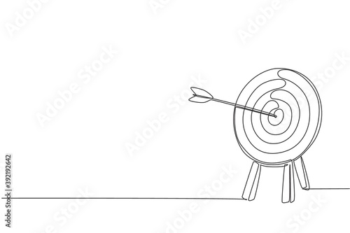 Photo One continuous line drawing of arrow was shot bullseye to archery target board