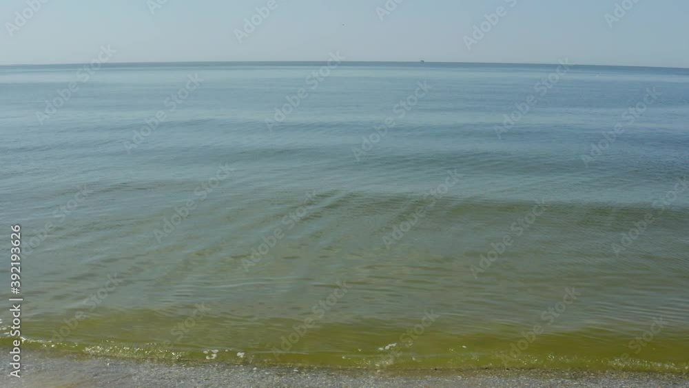 Sea waves rolling on sandy beach, slow motion effect Sea waves rolling on sandy beach, slow motion effect