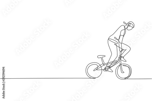 One single line drawing of young bmx bicycle rider performing freestyle trick on street vector illustration. Extreme sport concept. Modern continuous line draw design for freestyle competition banner