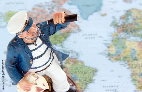 Obraz na plátně Small doll of a sea captain observing new lands.