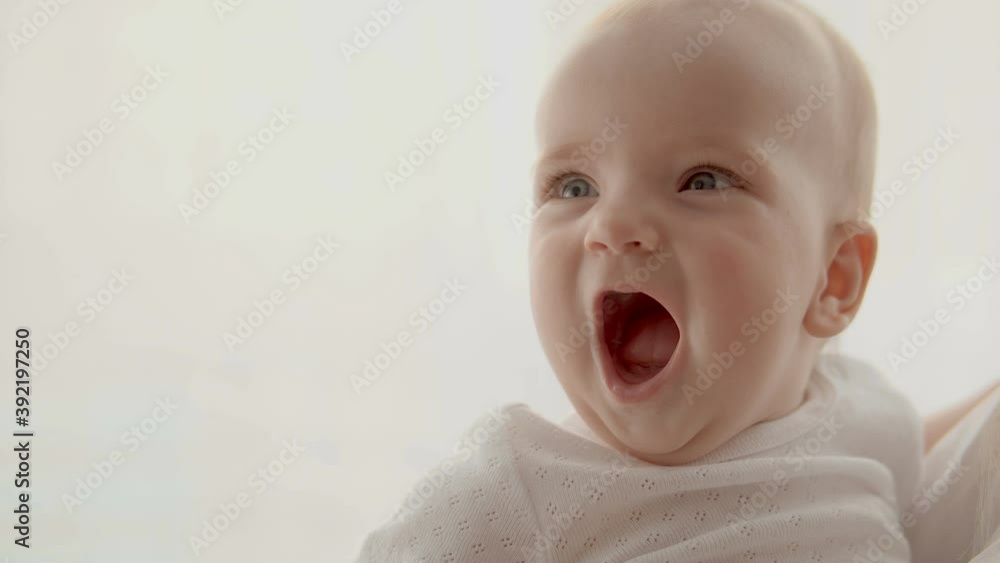 Surprised child watching all around, opening mouth in excitement, delight Surprised child watching all around, opening mouth in excitement, delight