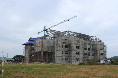 New construction site with crane Sunset sky background Steel frame structure, steel beam Building a large building at the construction site Construction machinery © วอน จังมึง