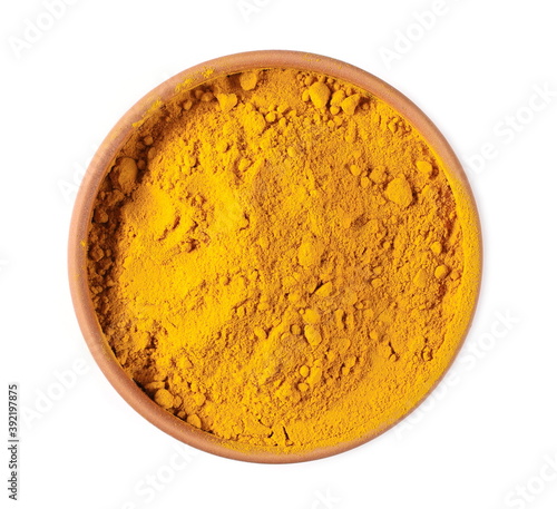 Turmeric powder (Curcuma) in bowl, pot isolated on white background, top view
