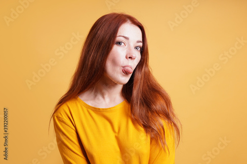 cheeky sassy silly young woman sticking out tongue
