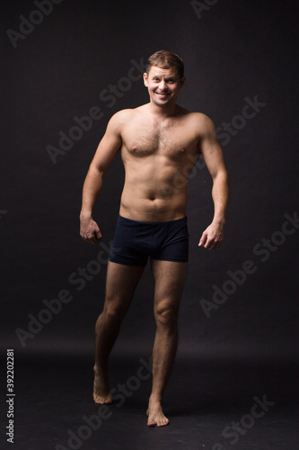 Handsome man in underwear on the black background. Muscular and athletic. Underwear man portrait. Male underwear model in studio