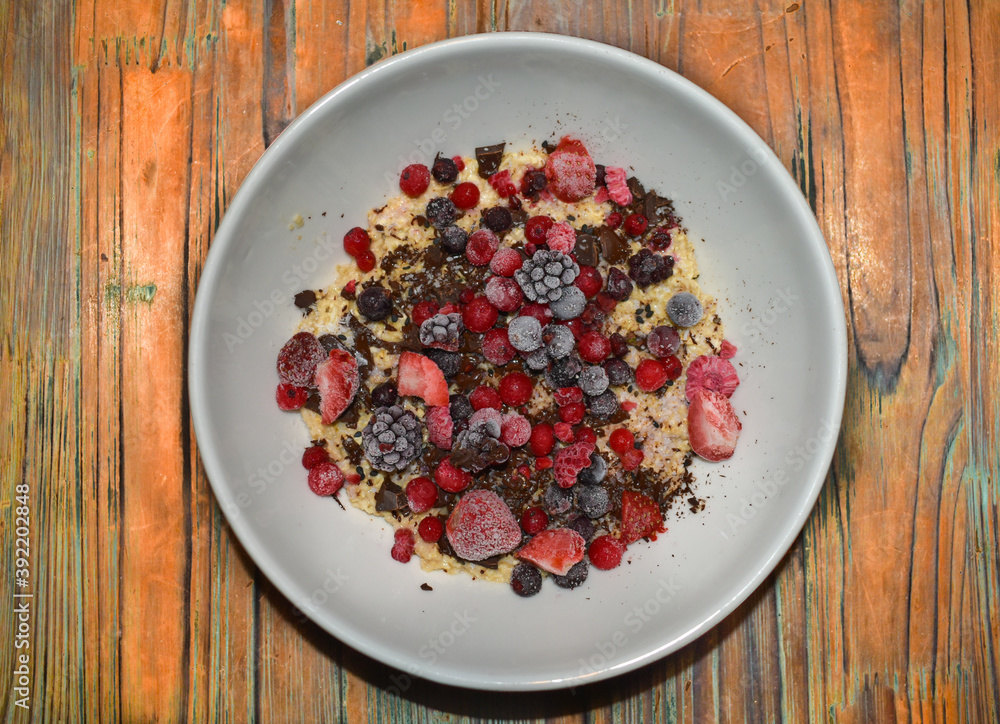 Bowl of oatmeal pudding with chocolate and berries. Bowl of oatmeal pudding with chocolate and berries.