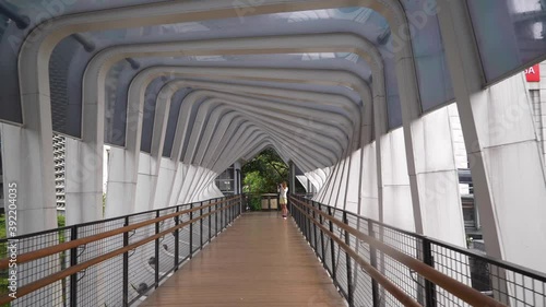 day time jakarta city center famous pedestrian bridge slow motion walking panorama 4k indonesia photo