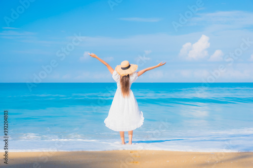 Portrait beautiful young asian woman relax smile leisure around sea beach ocean