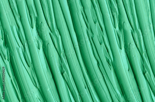 Green cosmetic clay  kelp facial mask  face cream  spirulina body wrap  texture close up  selective focus. Abstract background.