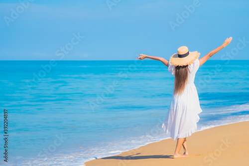 Portrait beautiful young asian woman relax smile leisure around sea beach ocean
